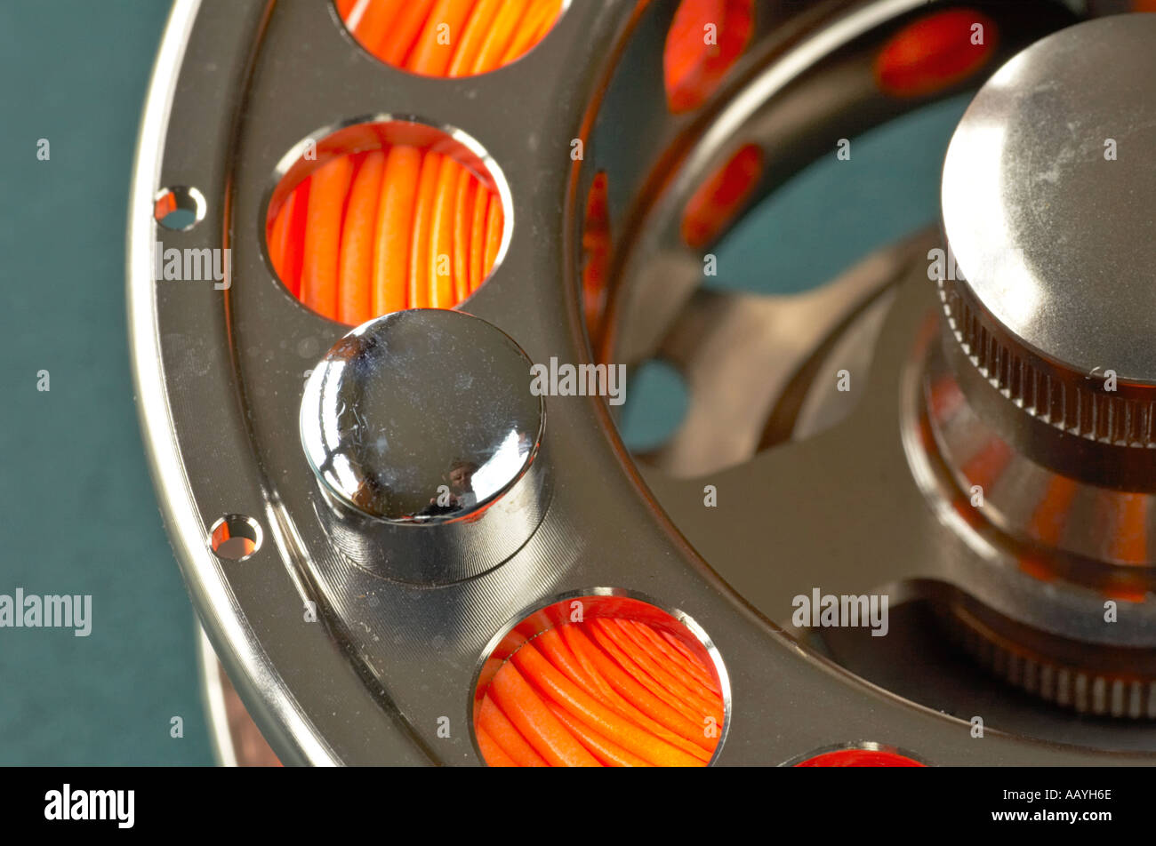 Detail of a fly fishing reel loaded with an orange fly line Stock Photo -  Alamy