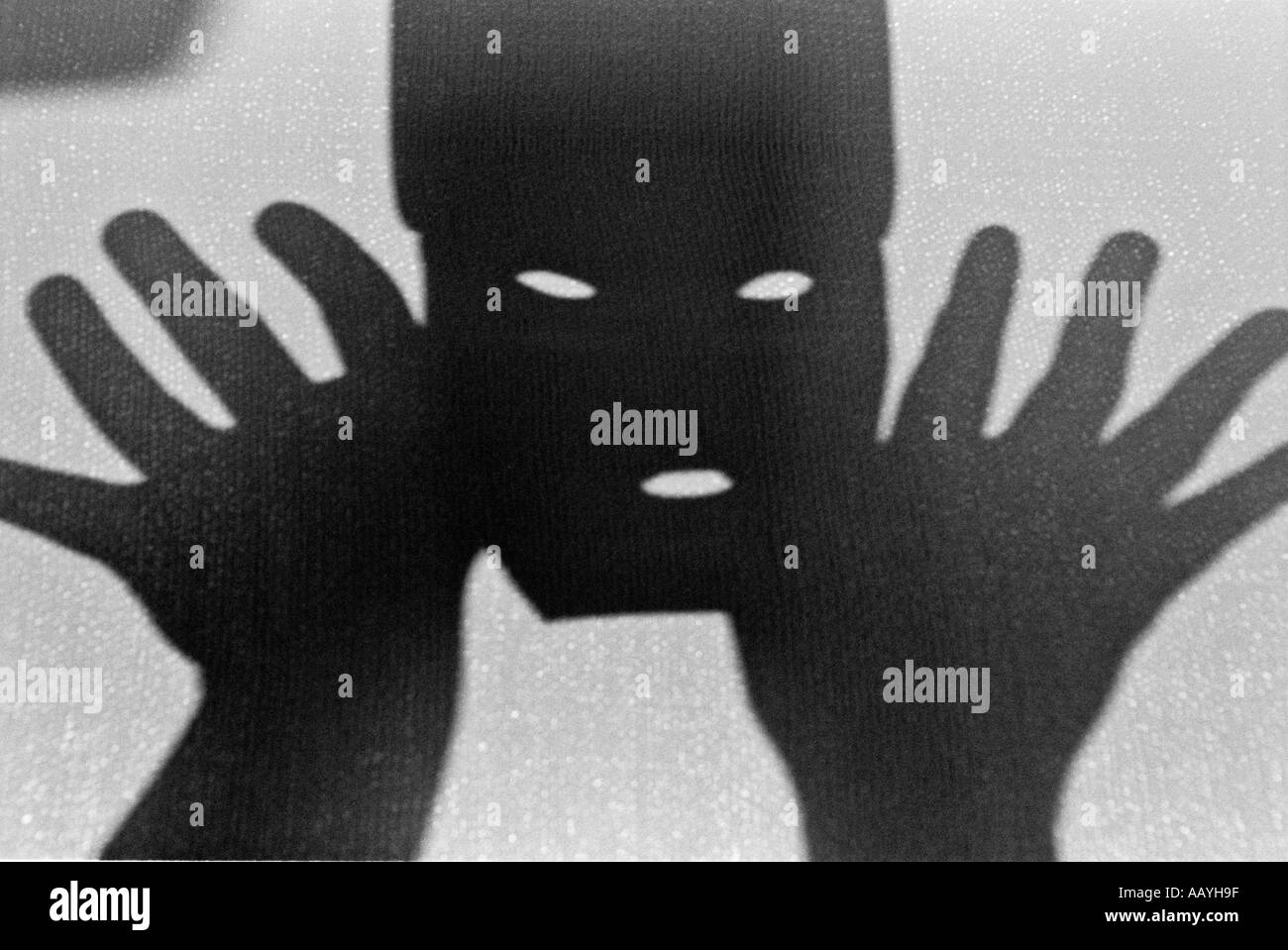 Mask of face with slits for two eyes and nose to breath and two hands Stock Photo