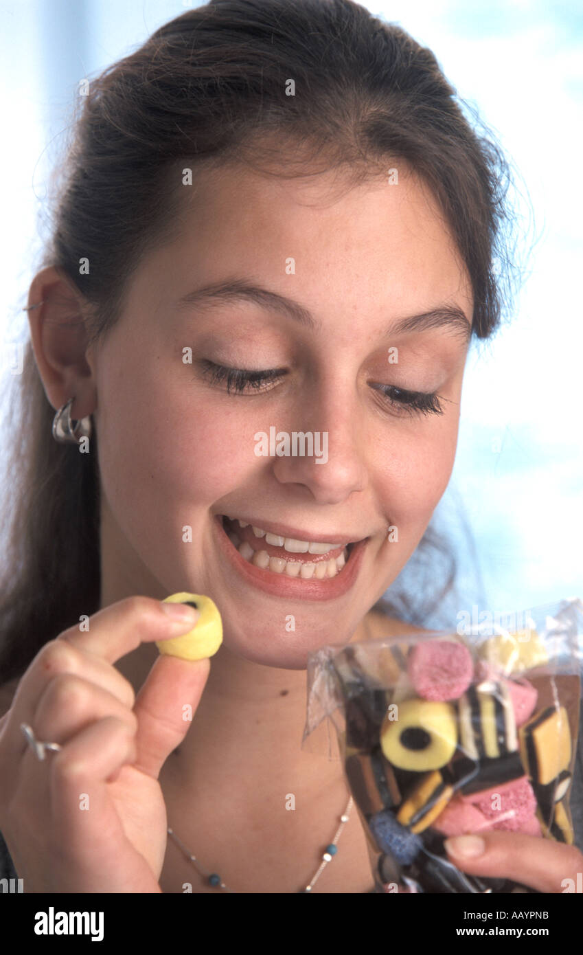 Teenage girl eating candy Stock Photo Alamy