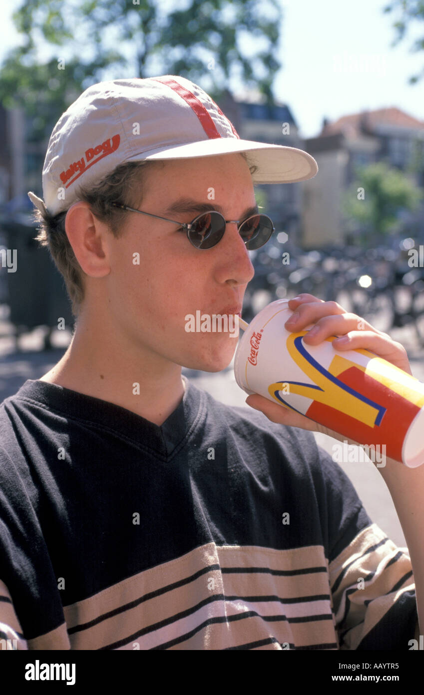 Teenage boy eating snacks Stock Photo - Alamy