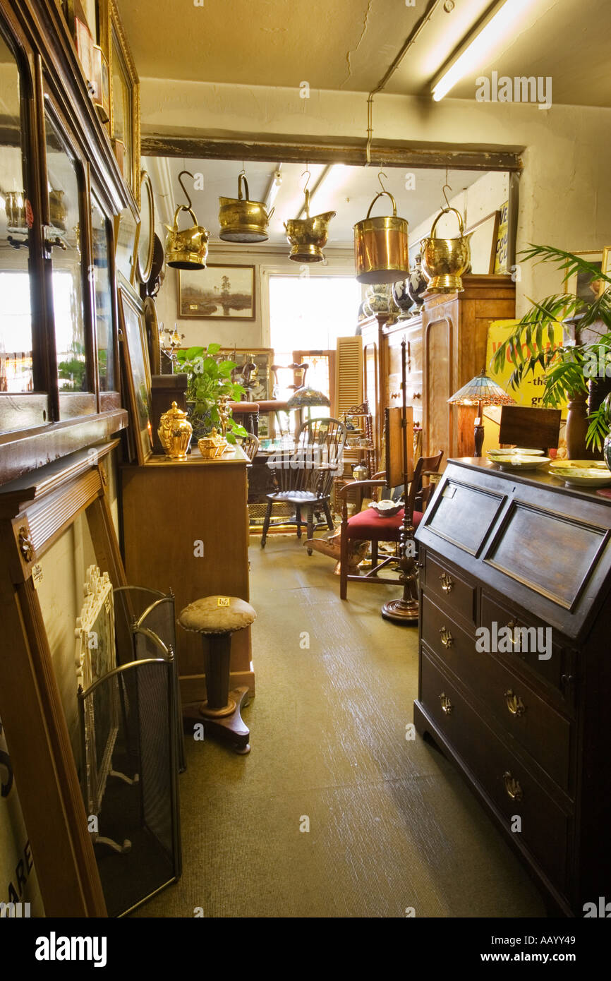 Antiques store shop interior with old furniture, England UK Stock Photo