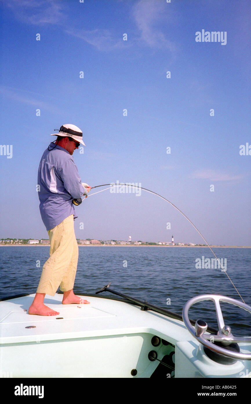 Man fly fishing off bow of boat in Savannah USA Model and