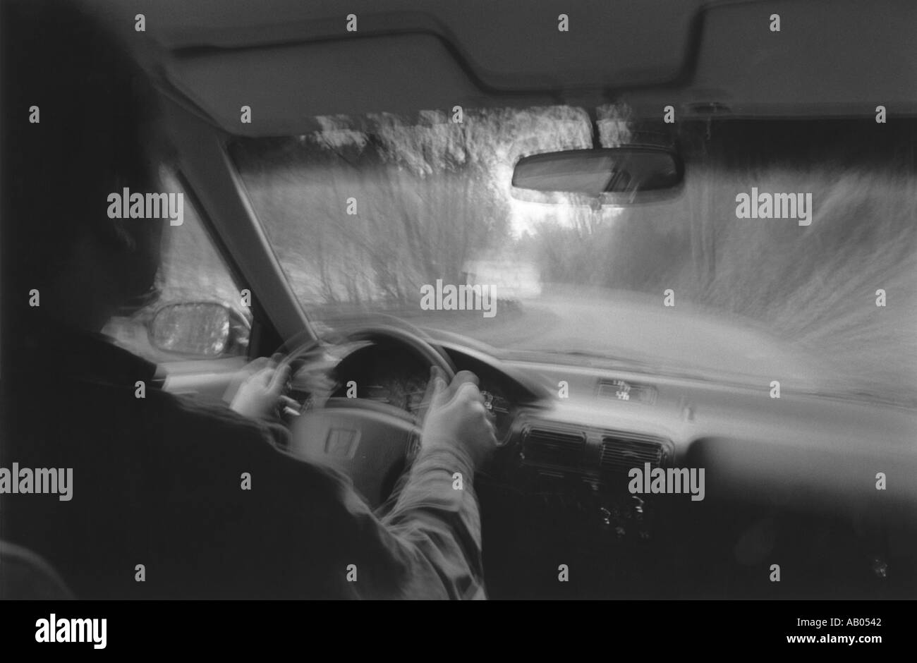 Looking through the windshield of car driving on road with blurred effect Stock Photo