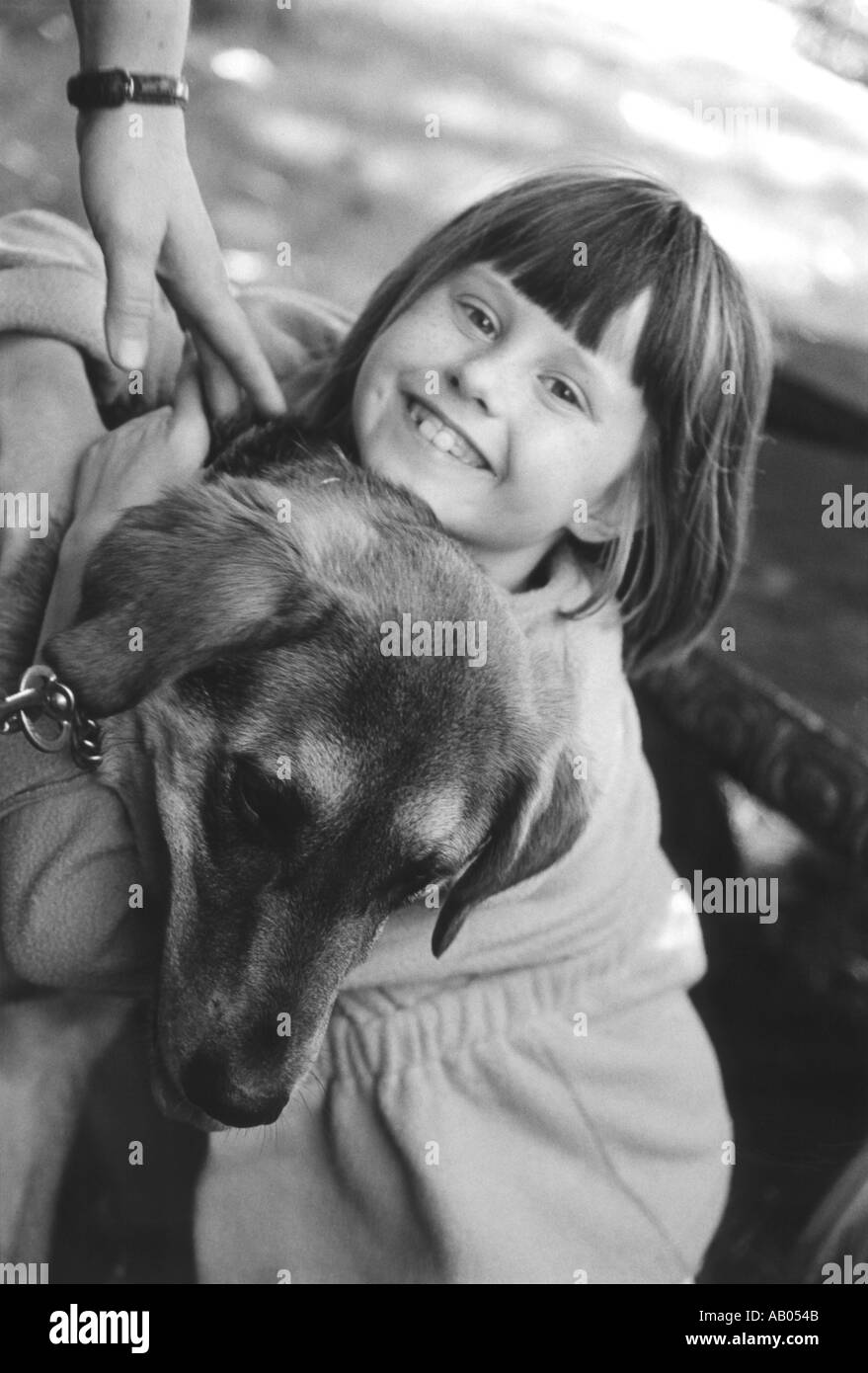 Young girl hugging dog Stock Photo