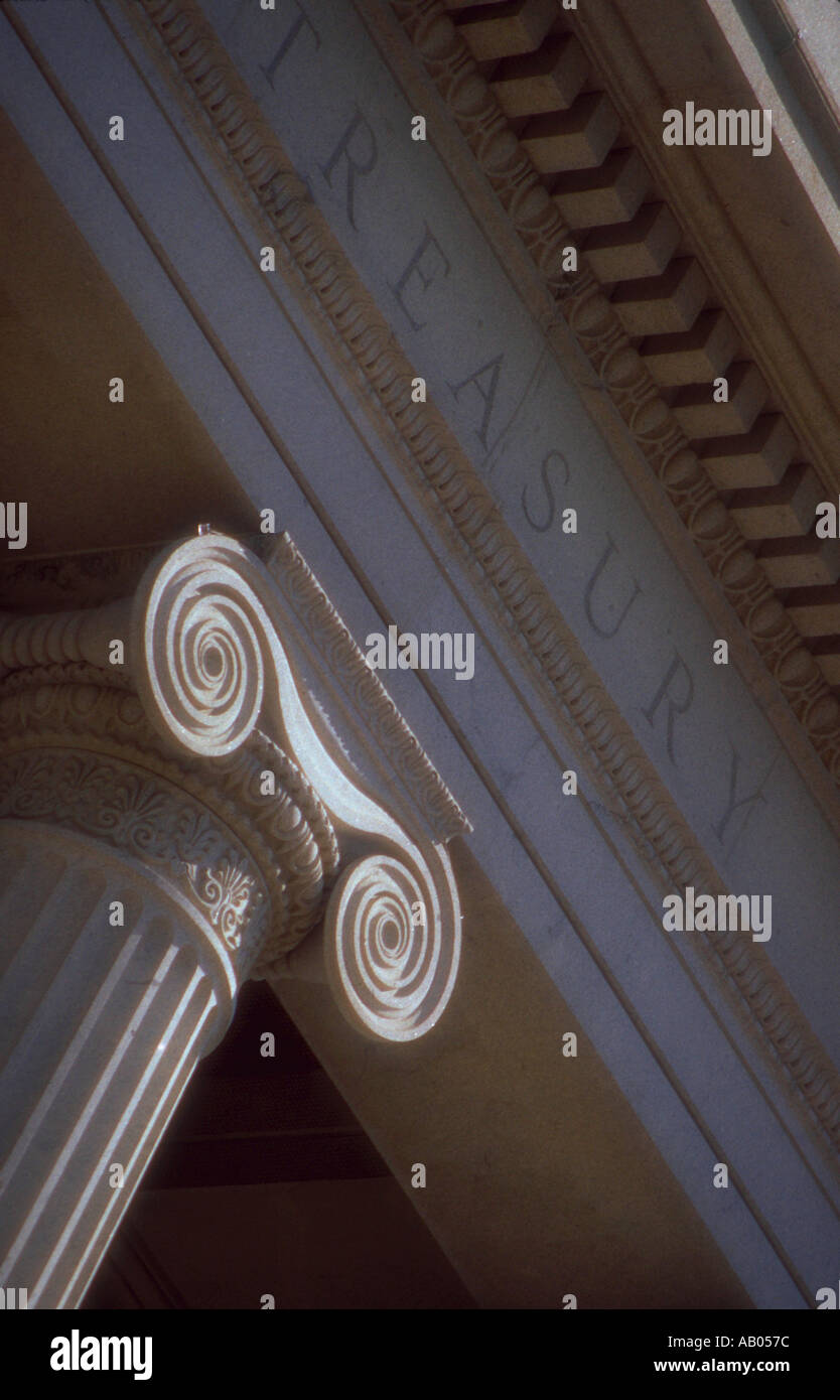 Close up of the top of a column and the word Treasury on the front of the Treasury Building in Washington District of Columbia Stock Photo