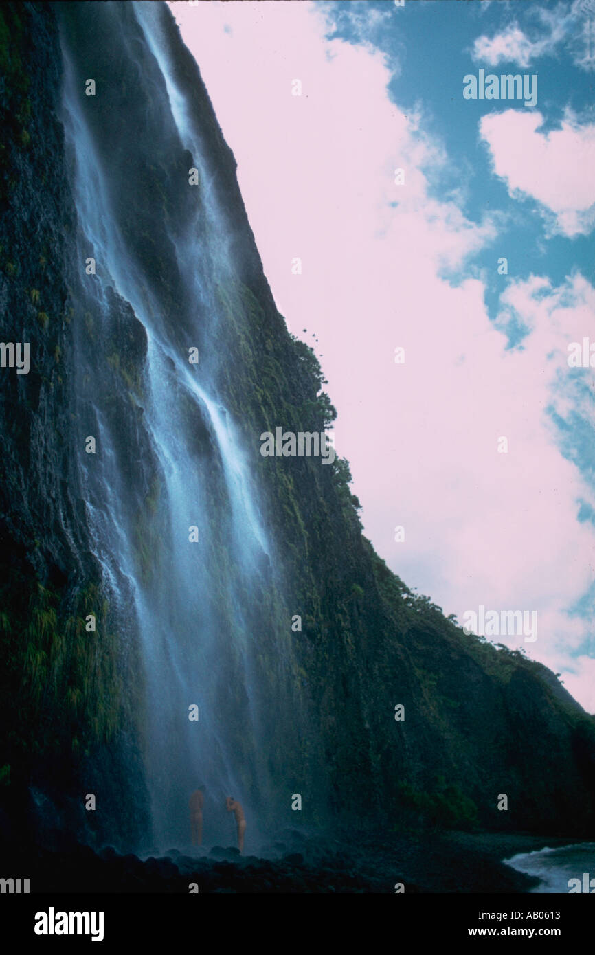 A waterfall showering hikers standing below the spectacular precipitous