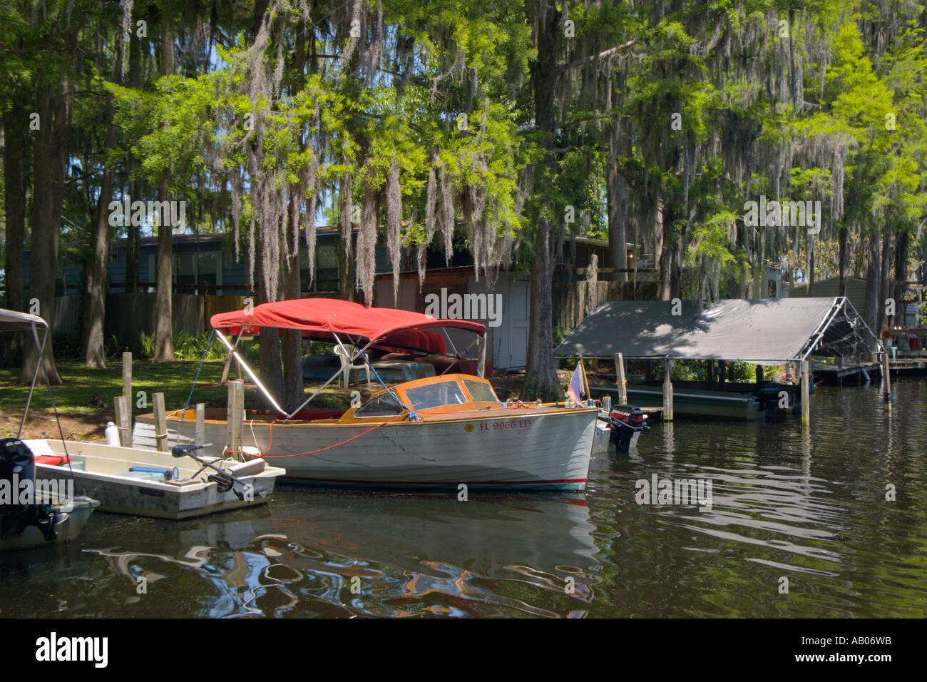 Lake Rousseau Rv Resort Wooden boat docked under cypress trees with spanish moss in the marina ...