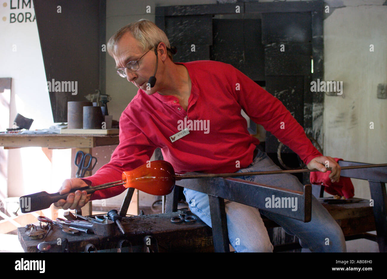 Glass blower demonstrates talent and skills while making a glass