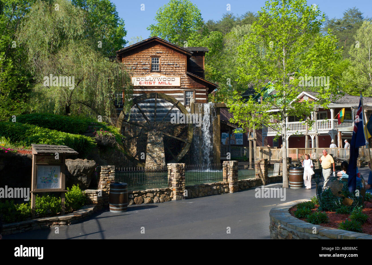 Park visitors walking past Grist Mill at Dollywood theme park in Pigeon Forge, Tennessee, USA Stock Photo