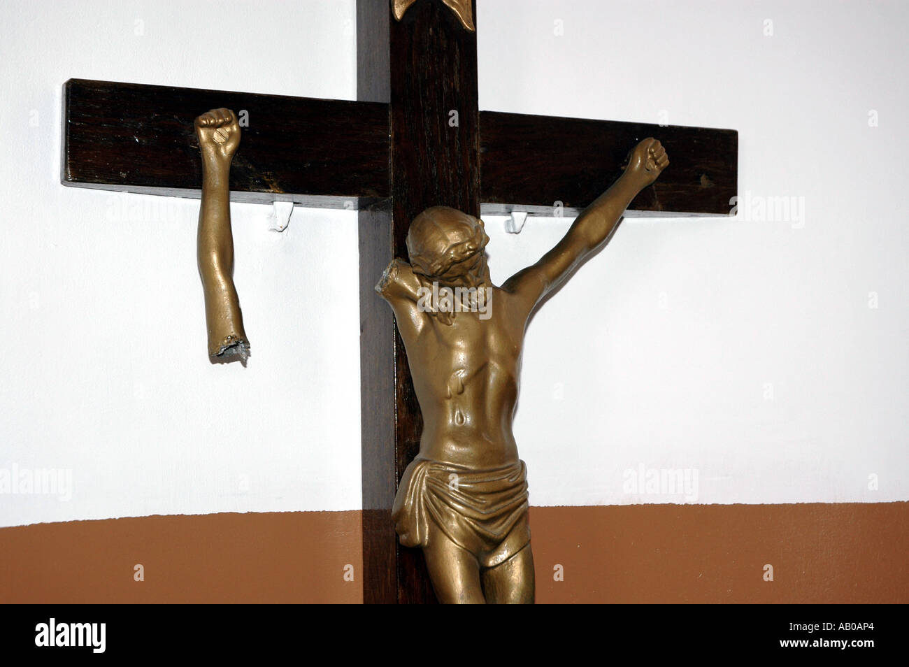 Jesus on a cross with broken arm destroyed by vandals Stock Photo 
