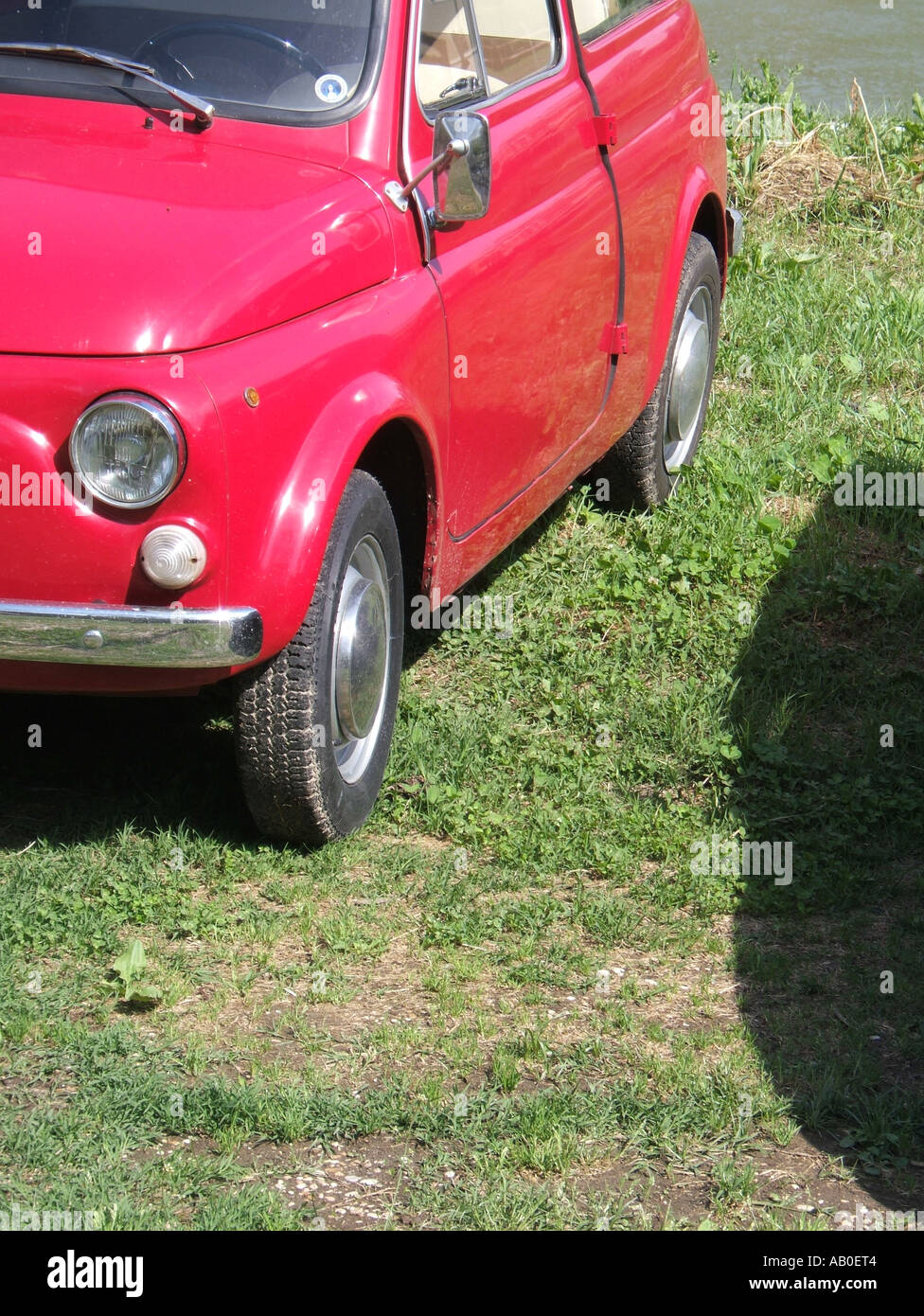 one old red fiat 500 car parked on grass Stock Photo - Alamy