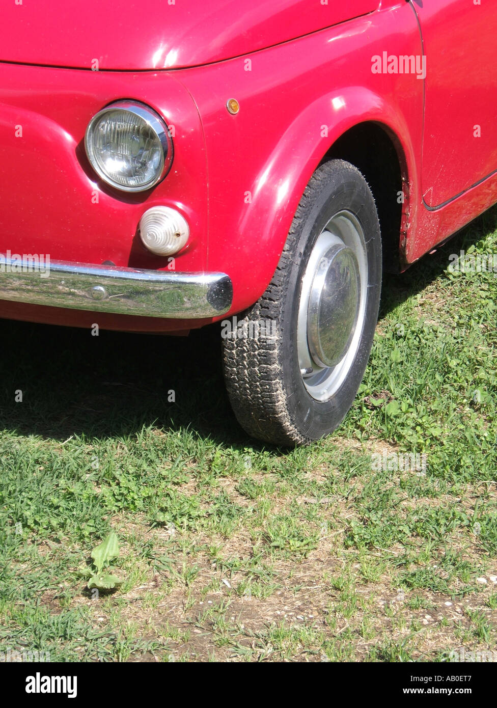 one old red fiat 500 car parked on grass Stock Photo - Alamy