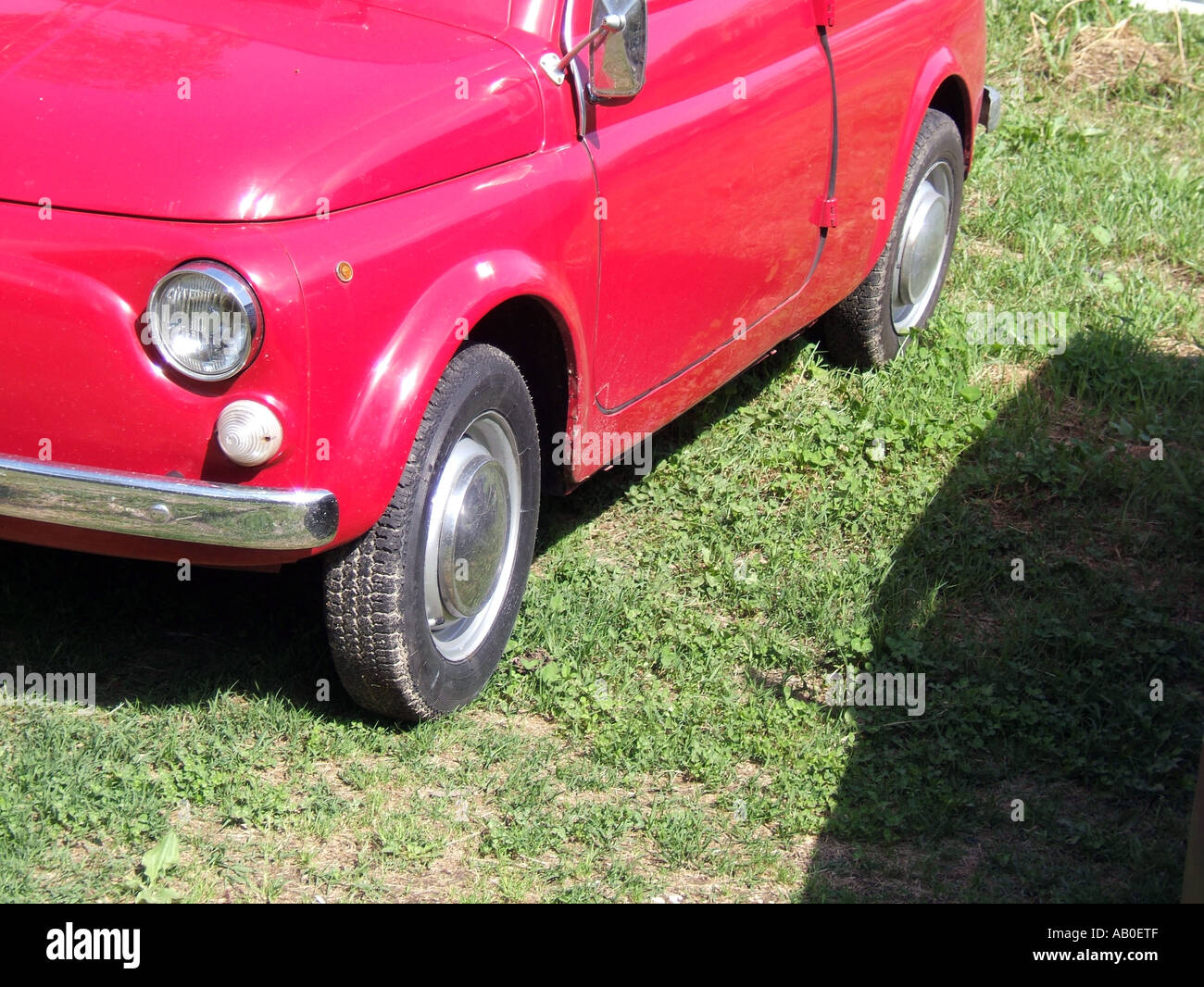 one old red fiat 500 car parked on grass Stock Photo - Alamy
