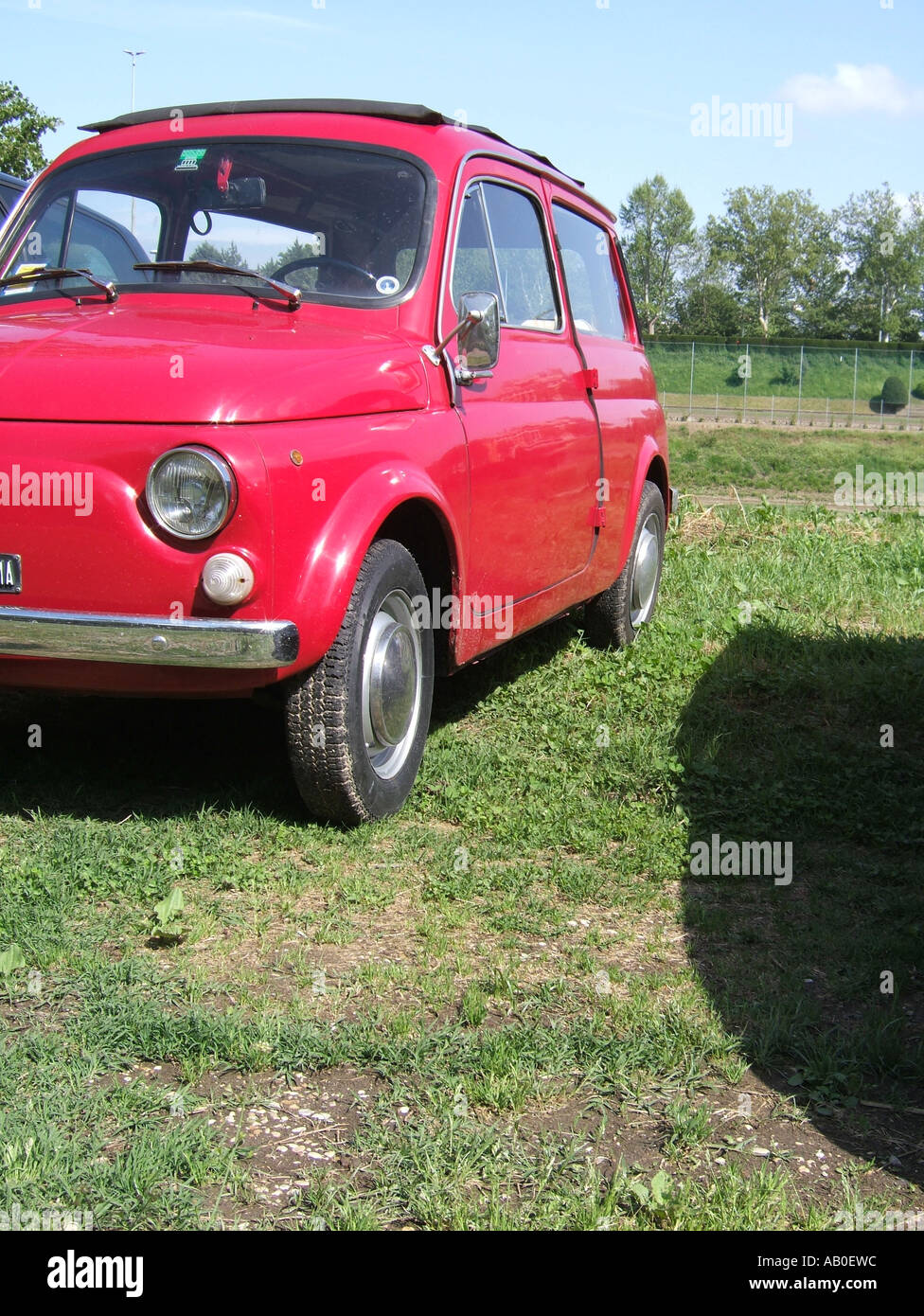 one old red fiat 500 car parked on grass Stock Photo - Alamy