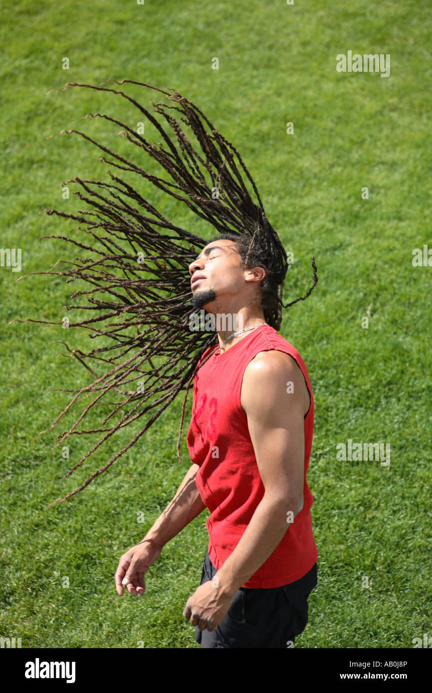 Man with his dreadlocks flying in the air Stock Photo