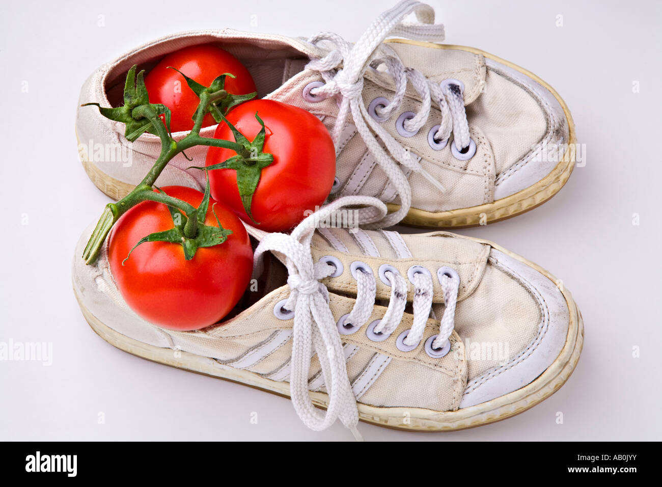 Dirty sneakers and tomatoes Stock Photo