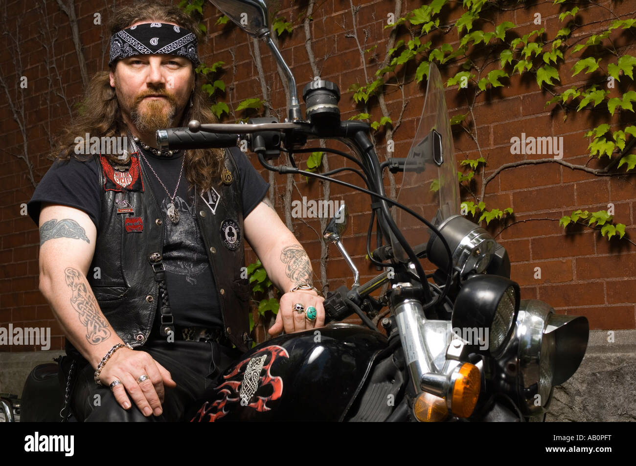 Bandana Motorcyclist, black leather jacket and tattoos Stock Photo - Alamy