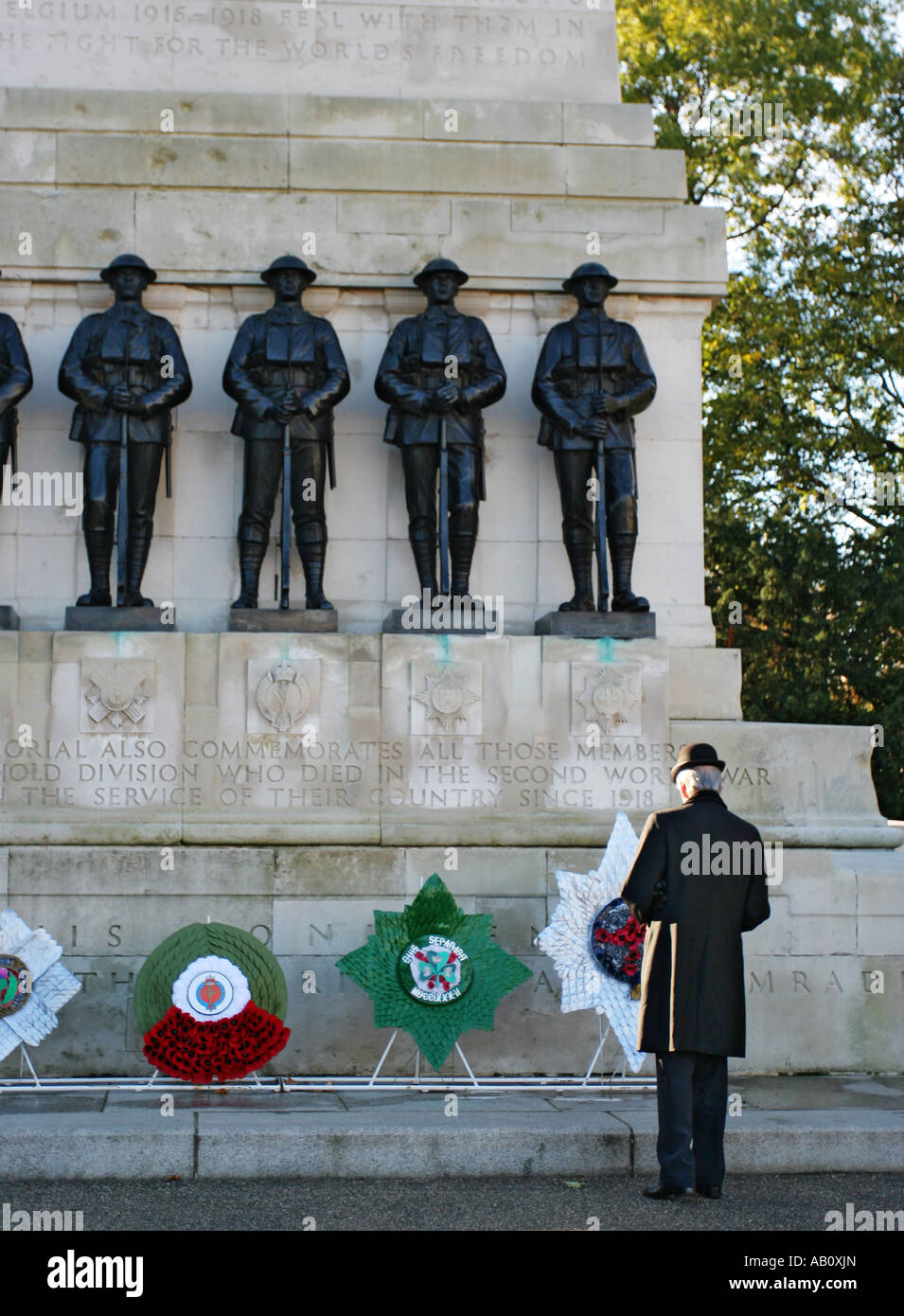 A single male OAP laying a wreath at the first world war memorial at St James Park London Stock Photo
