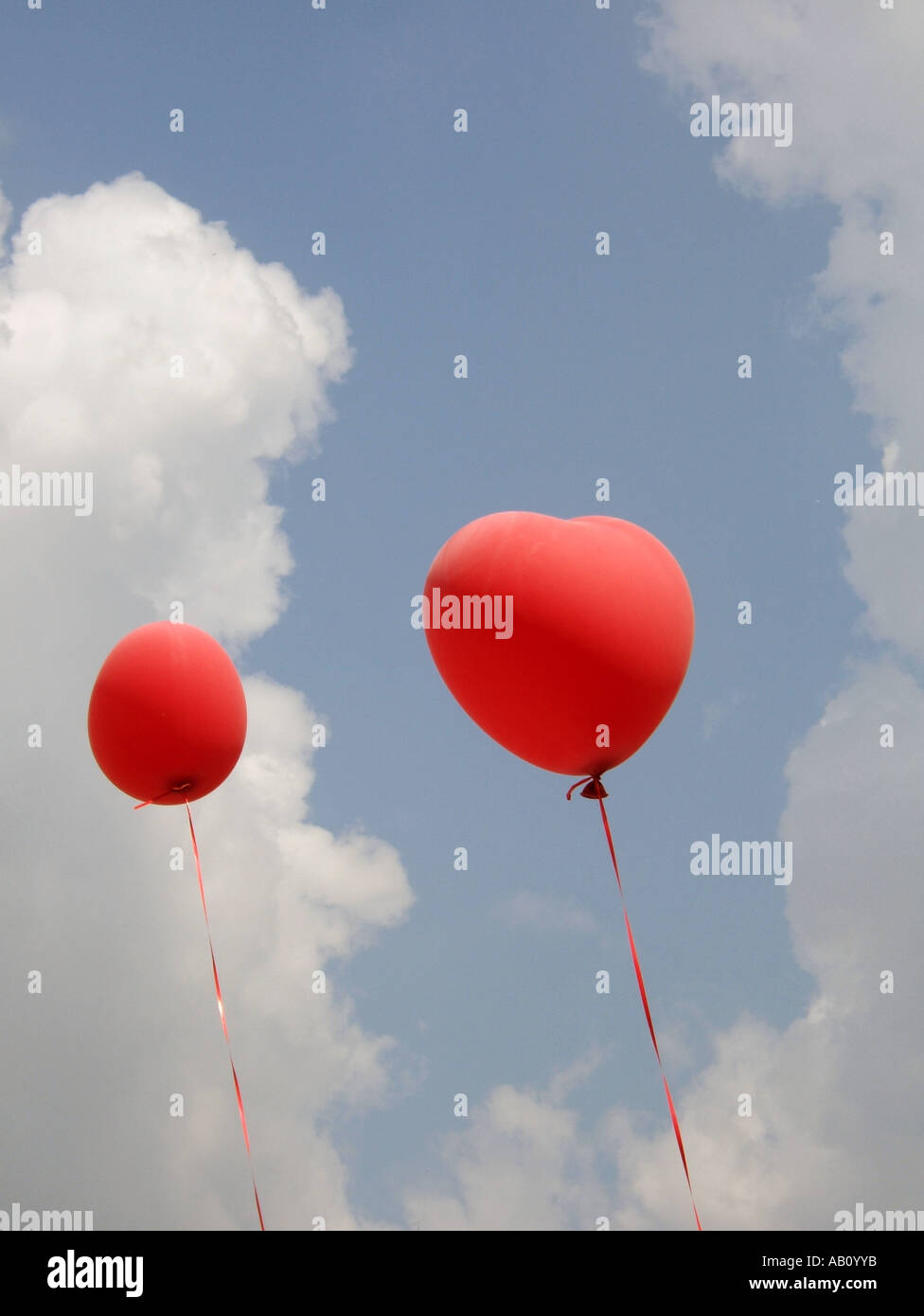 two heart shaped red balloons in blue sky Stock Photo - Alamy