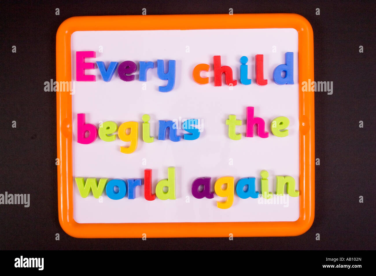 'Every child begins the world again', a quote by Henry David Thoreau written with colourful plastic letters on a whiteboard. Stock Photo