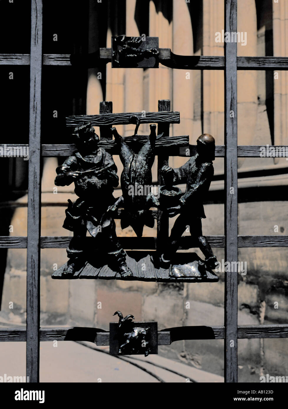 Detail of a cast metal grill of butcher slaughtering a pig, St Vitus's Cathedral, Prague Castle, Prague, Czech Republic. Stock Photo