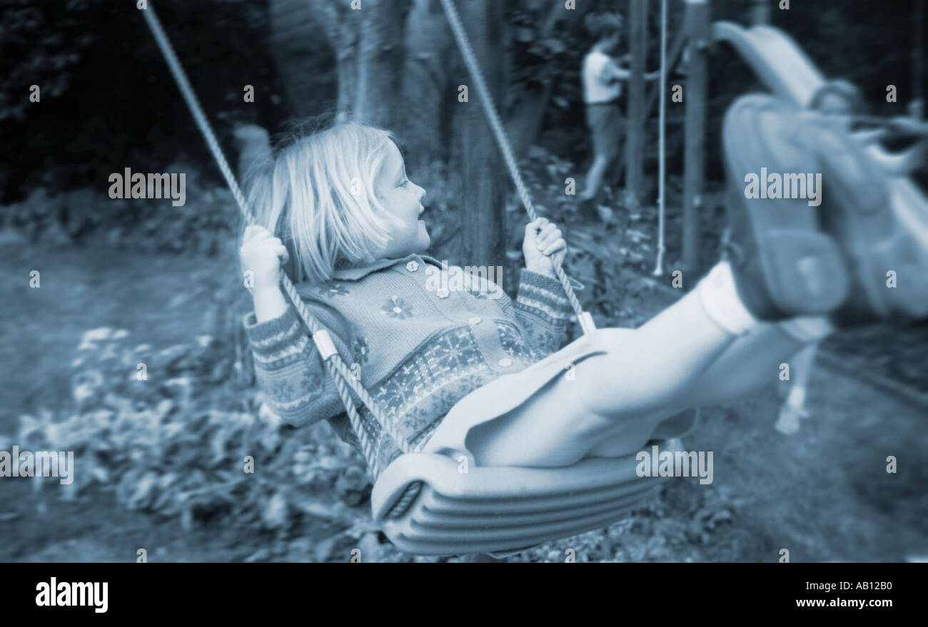 Child on a swing in the garden Stock Photo