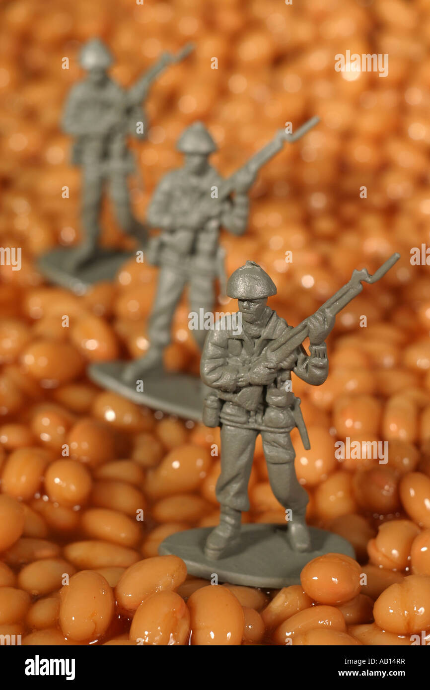 Toy soldiers marching in baked beans Stock Photo