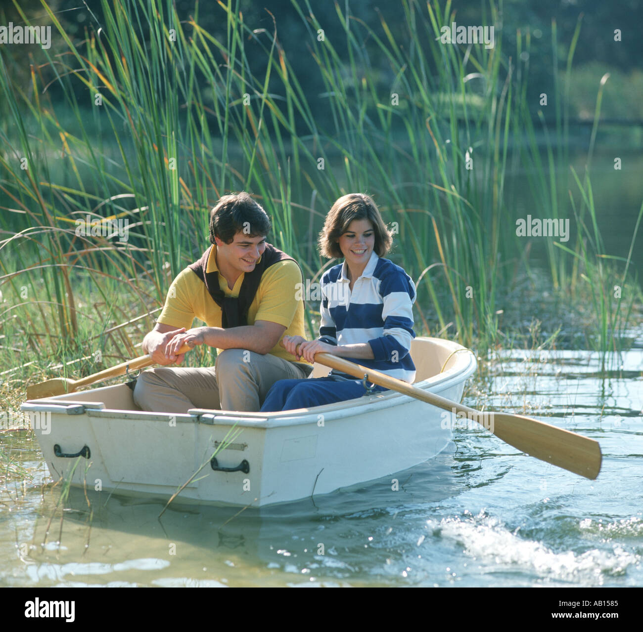 romantic couple enjoying a rowboat ride Stock Photo 