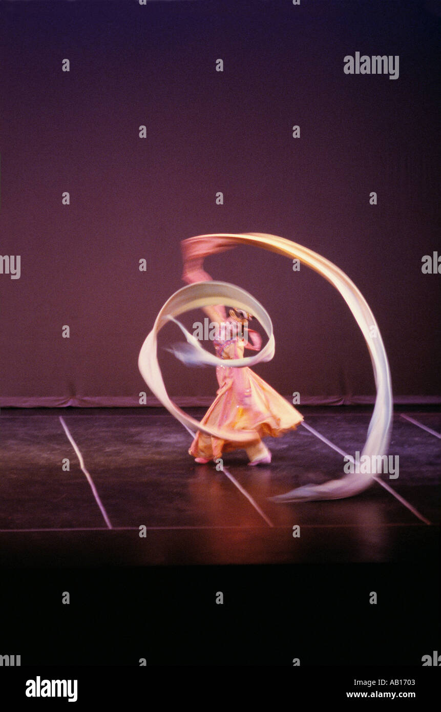 Performer doing the Rainbow Ribbon Dance on stage in China Stock Photo