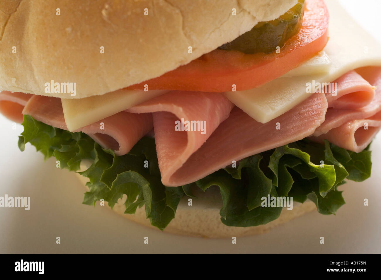 Ham cheese tomato and gherkin in kaiser roll FoodCollection Stock Photo