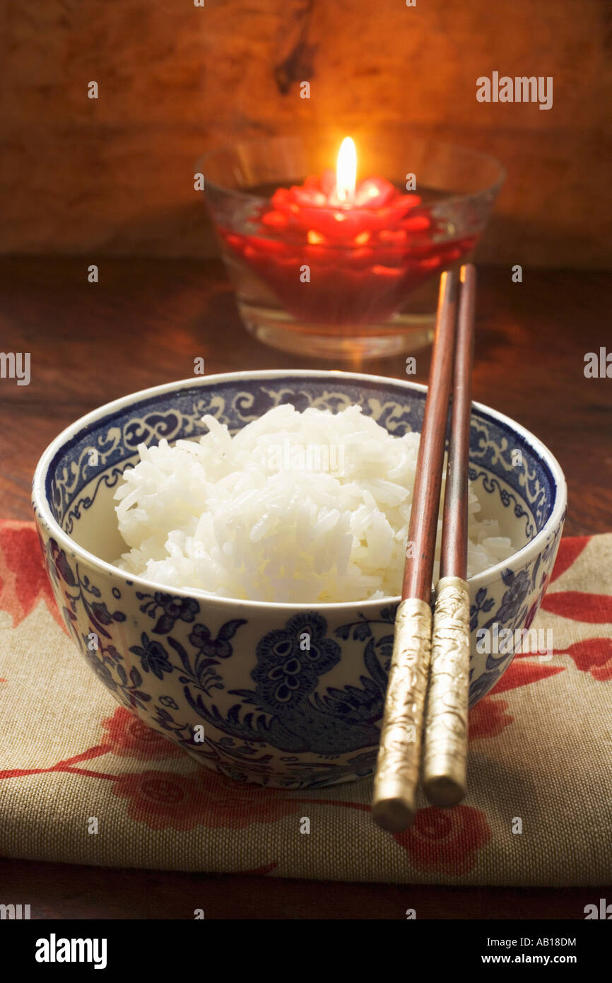Bowl of rice in front of floating candle Asia FoodCollection Stock ...