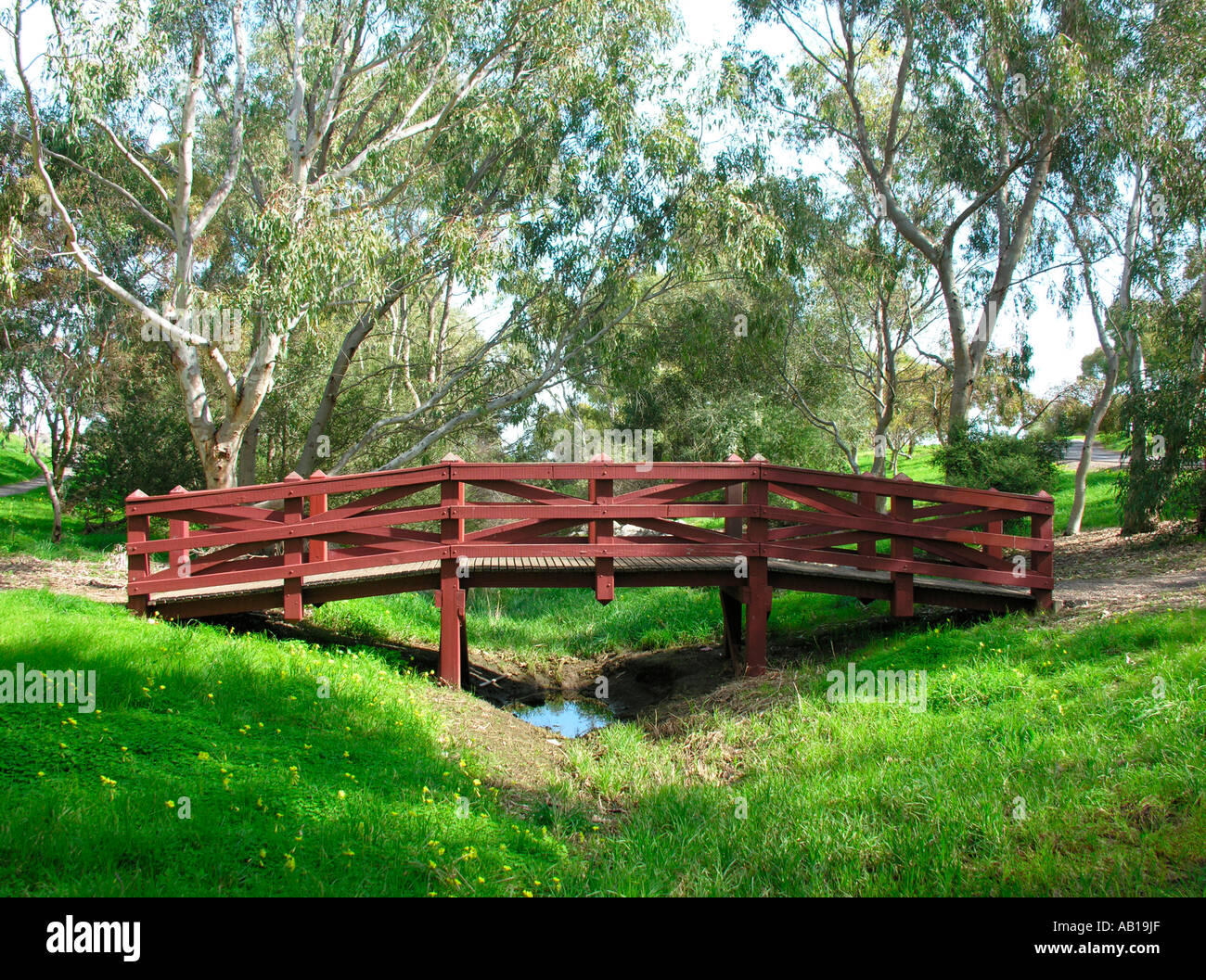 Wooden bridge across creek Stock Photo