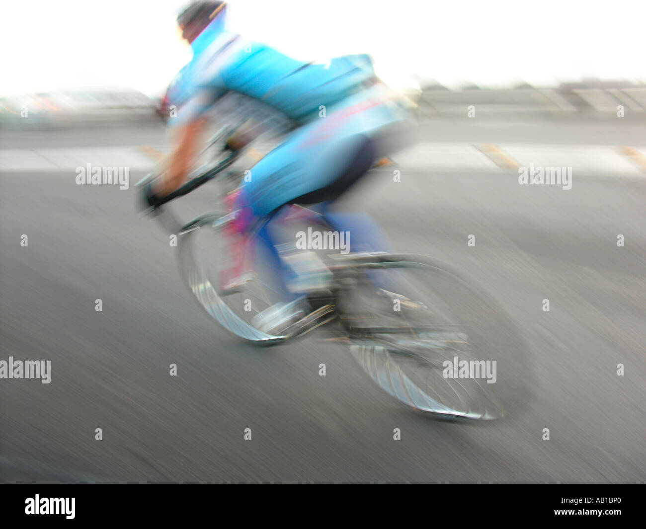 Racing bicycle rider leaning in bend motion blur Stock Photo