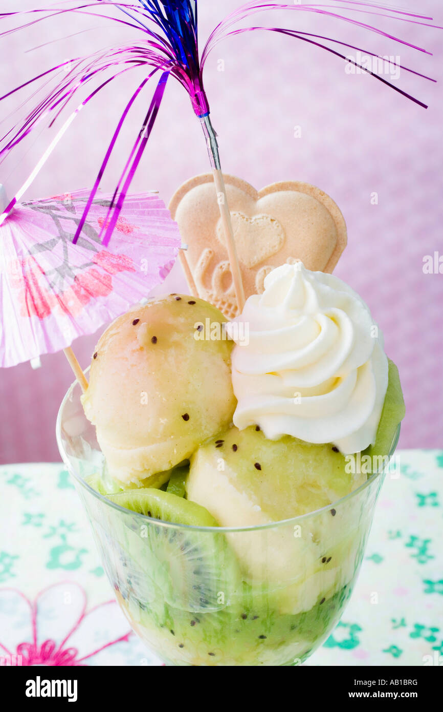Ice cream sundae with kiwi fruit cream cocktail umbrella FoodCollection ...