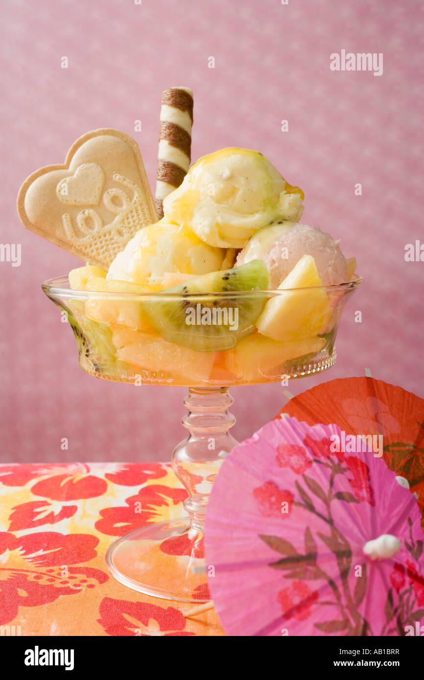 Ice cream sundae with fresh fruit cocktail umbrella FoodCollection ...