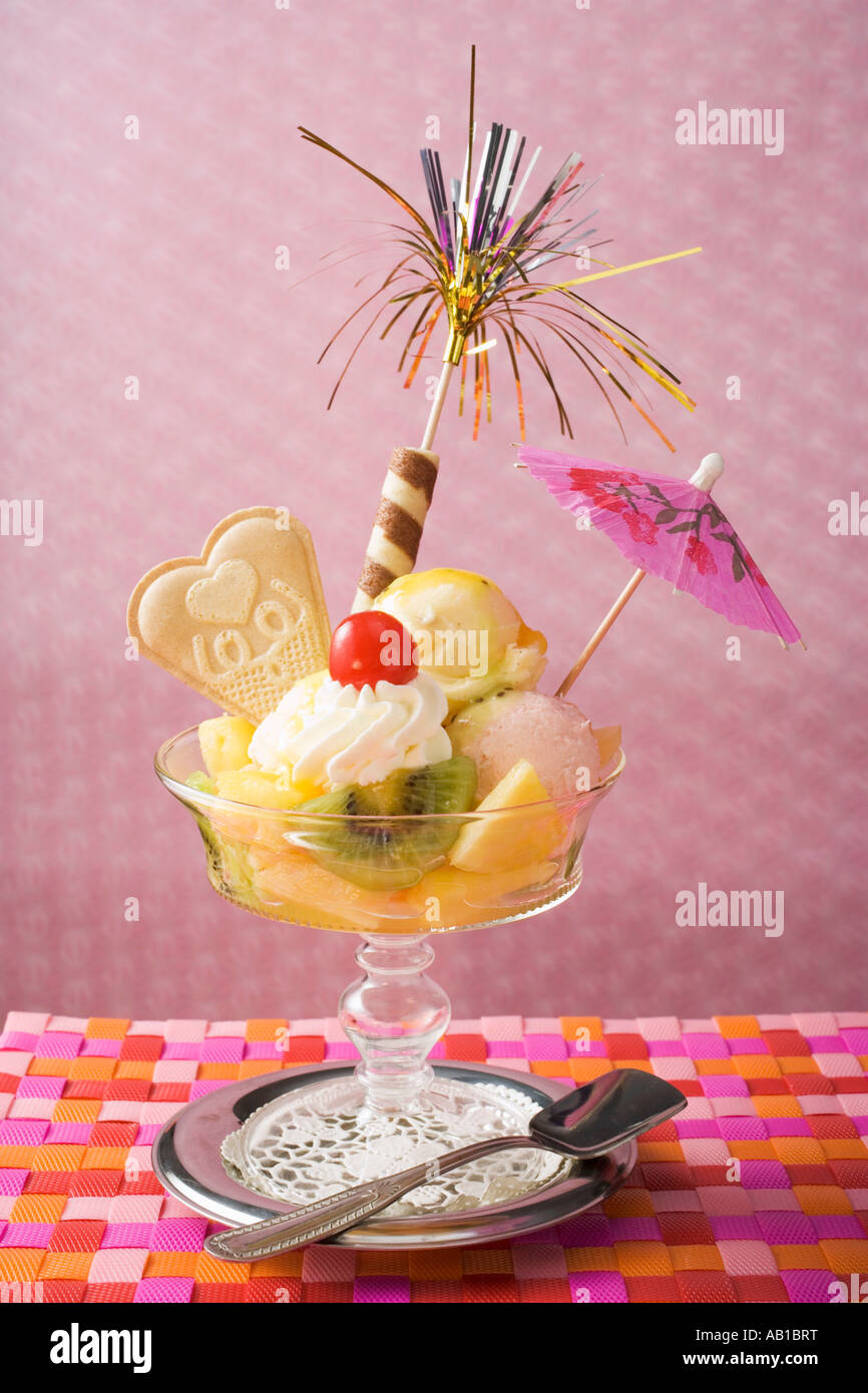 Ice cream sundae with fresh fruit and cocktail umbrella FoodCollection