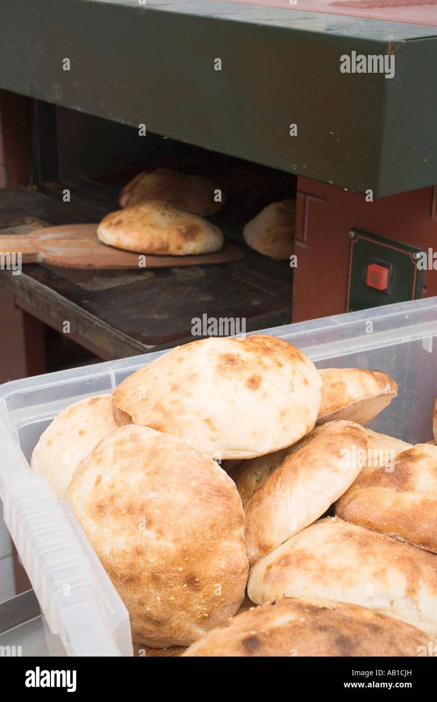 Pita bread in the oven and in a plastic crate FoodCollection Stock Photo