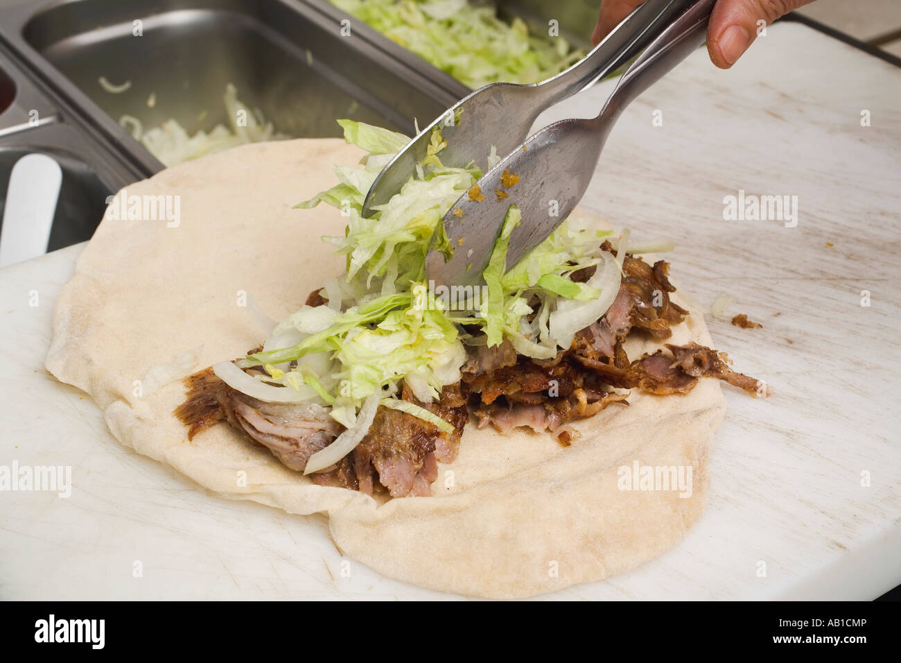 Making a döner wrap topping with lettuce FoodCollection Stock Photo - Alamy