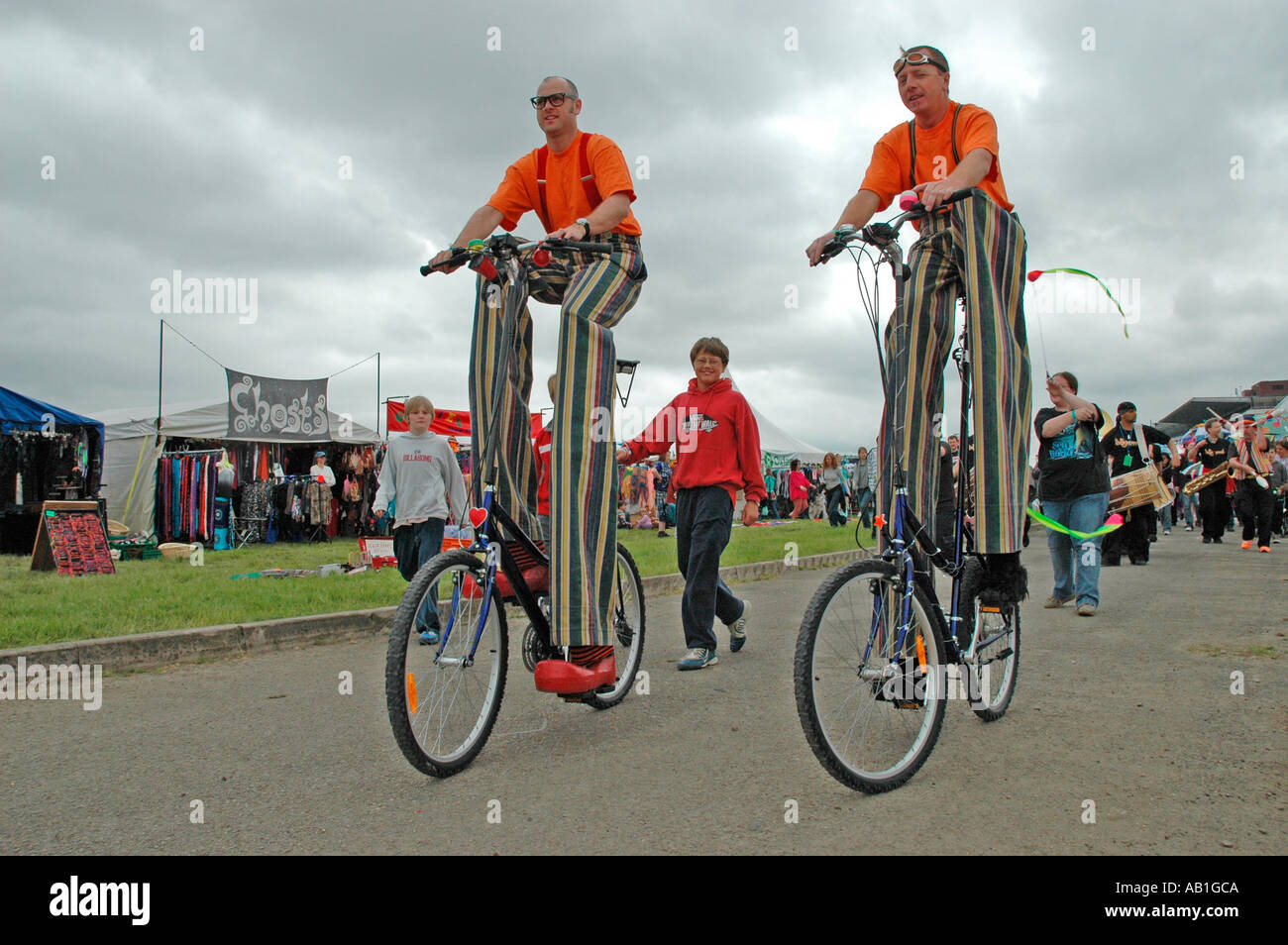 Stilt walkers riding bikes at the Wychwood Music Festival Cheltenham June 2005 Stock Photo