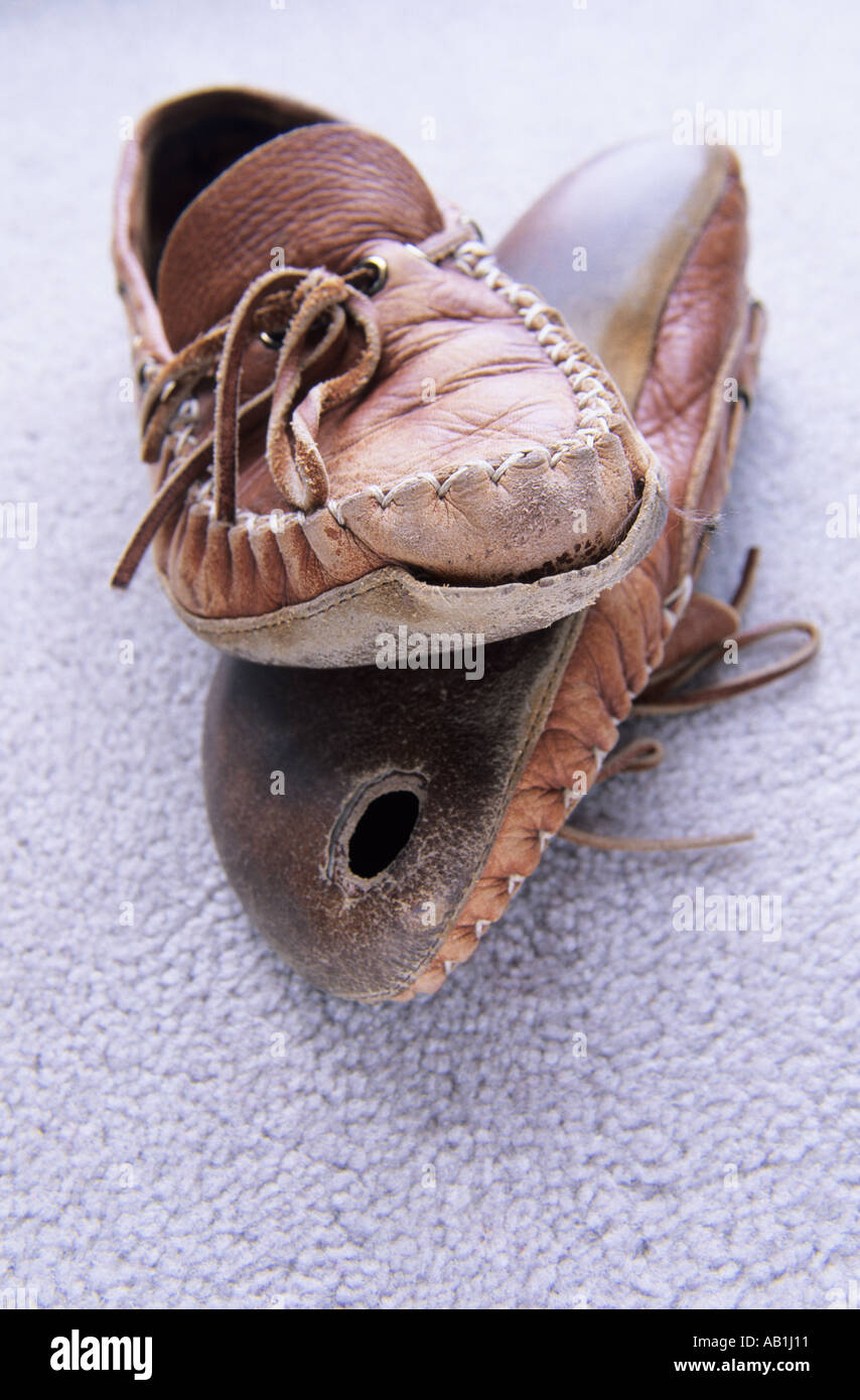 Concept image of worn out old slippers Stock Photo