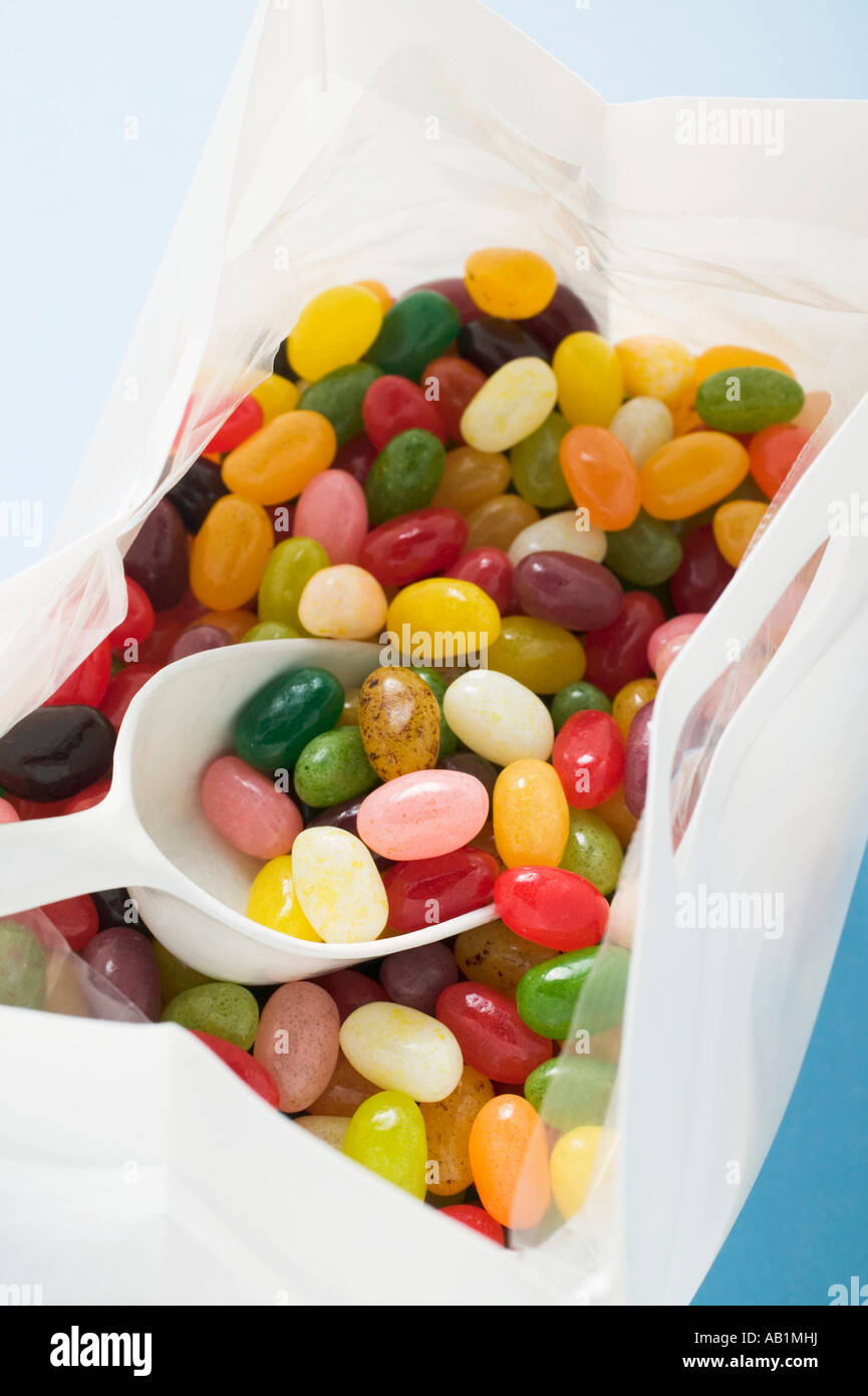 Coloured jelly beans in plastic bag with scoop detail FoodCollection