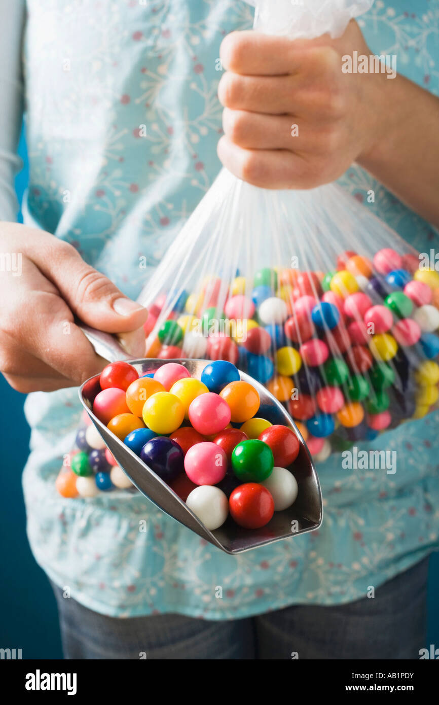 Hands holding plastic bag and scoop full of bubble gum balls FoodCollection  Stock Photo - Alamy
