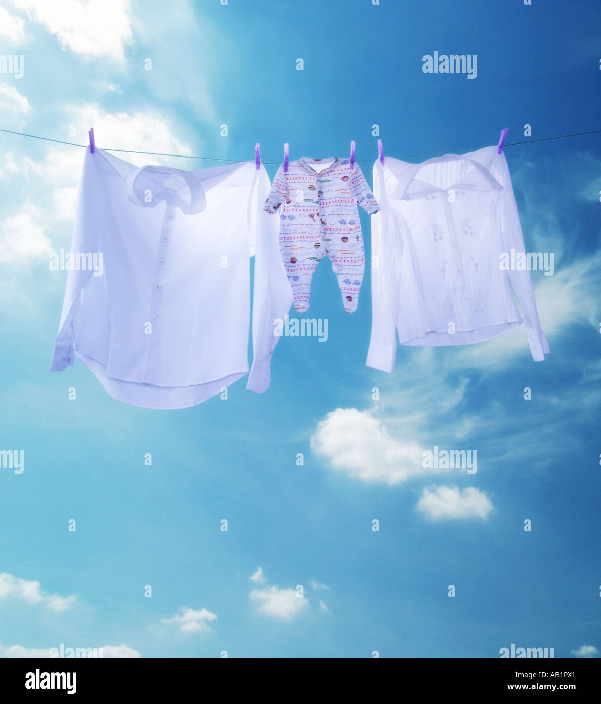 parent and baby clothes hanging on a washing line Stock Photo