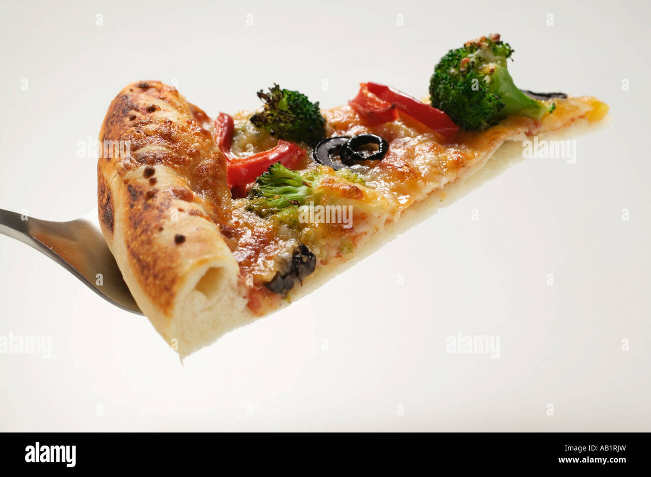 Slice of American style vegetable pizza on server FoodCollection Stock