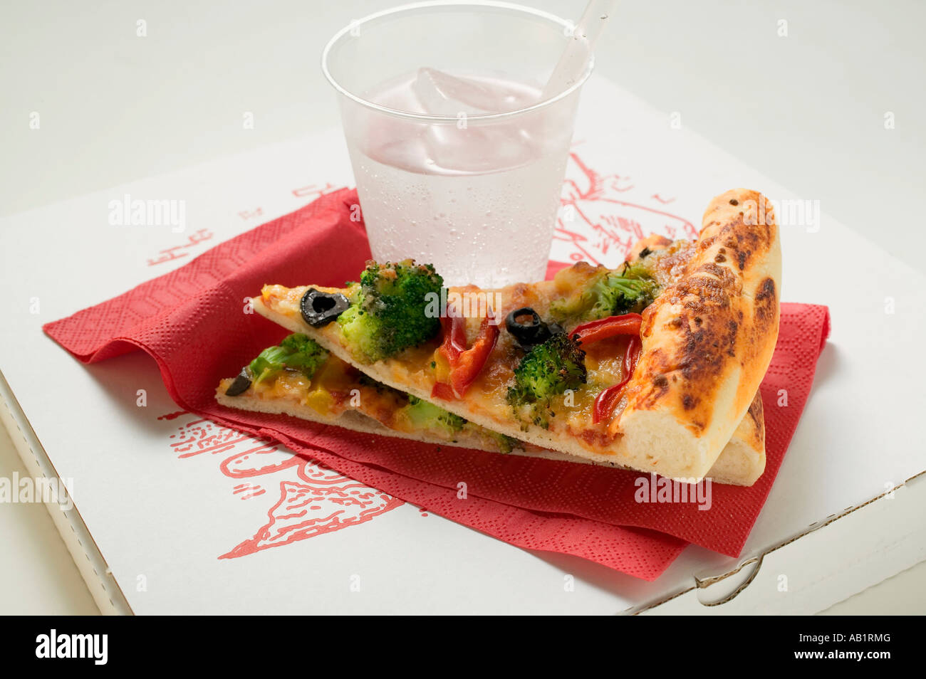 Two pieces of American style vegetable pizza mineral water