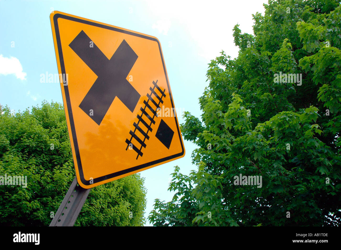 Train tracks and road intersection with both crossings ahead for cars and such in California America USA Stock Photo