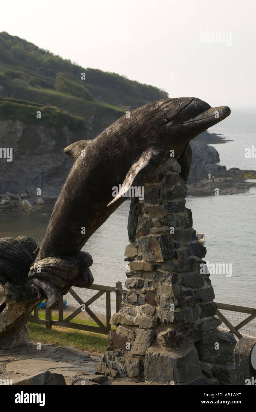 Carving of Dolphin Aberporth beach Cardigan Bay Ceredigion west wales UK Stock Photo