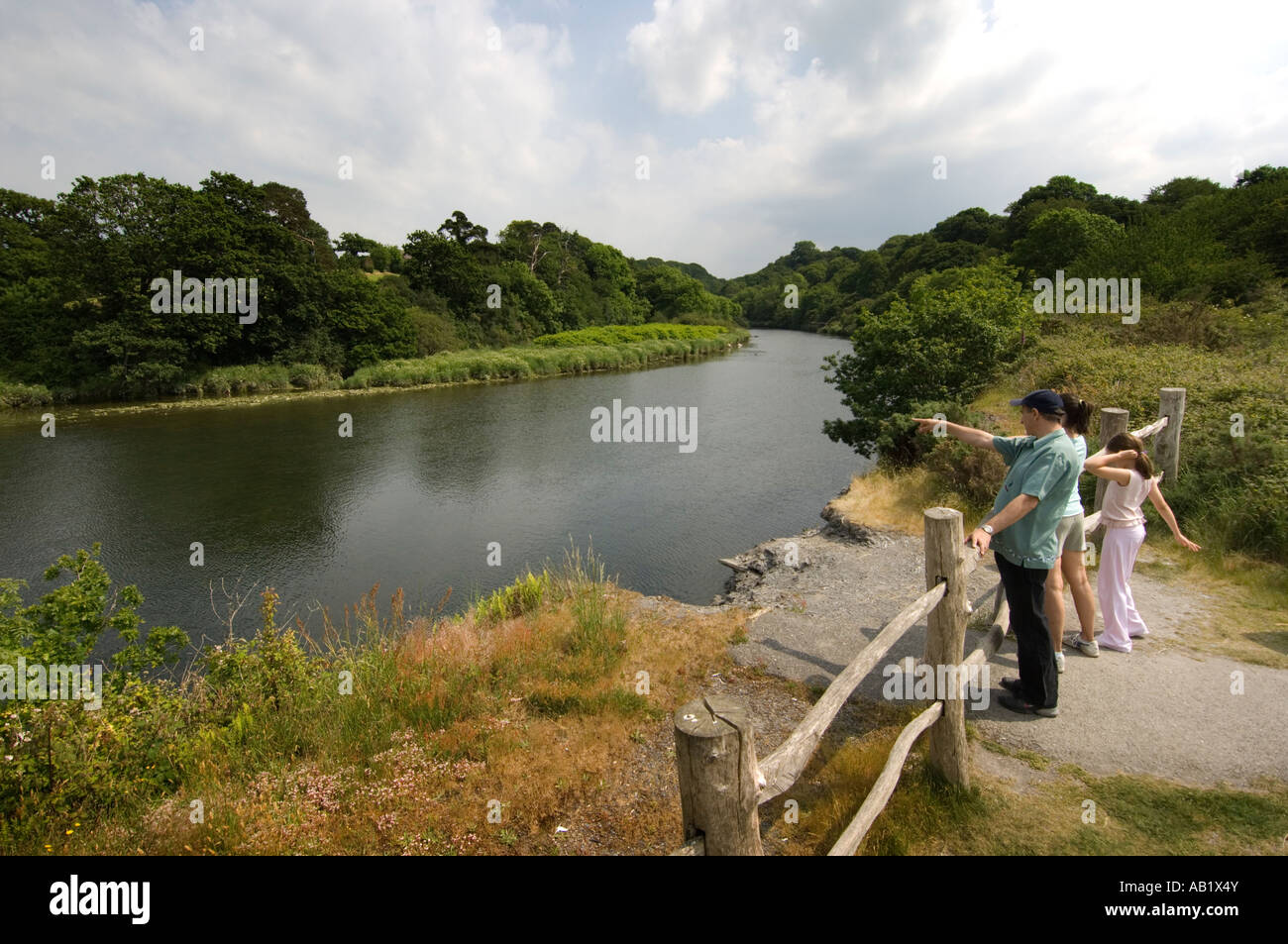 Family looking at the River Teifi at Wildlife and Wetlands Centre Cilgerran Pembrokeshire near Cardigan west Wales Stock Photo