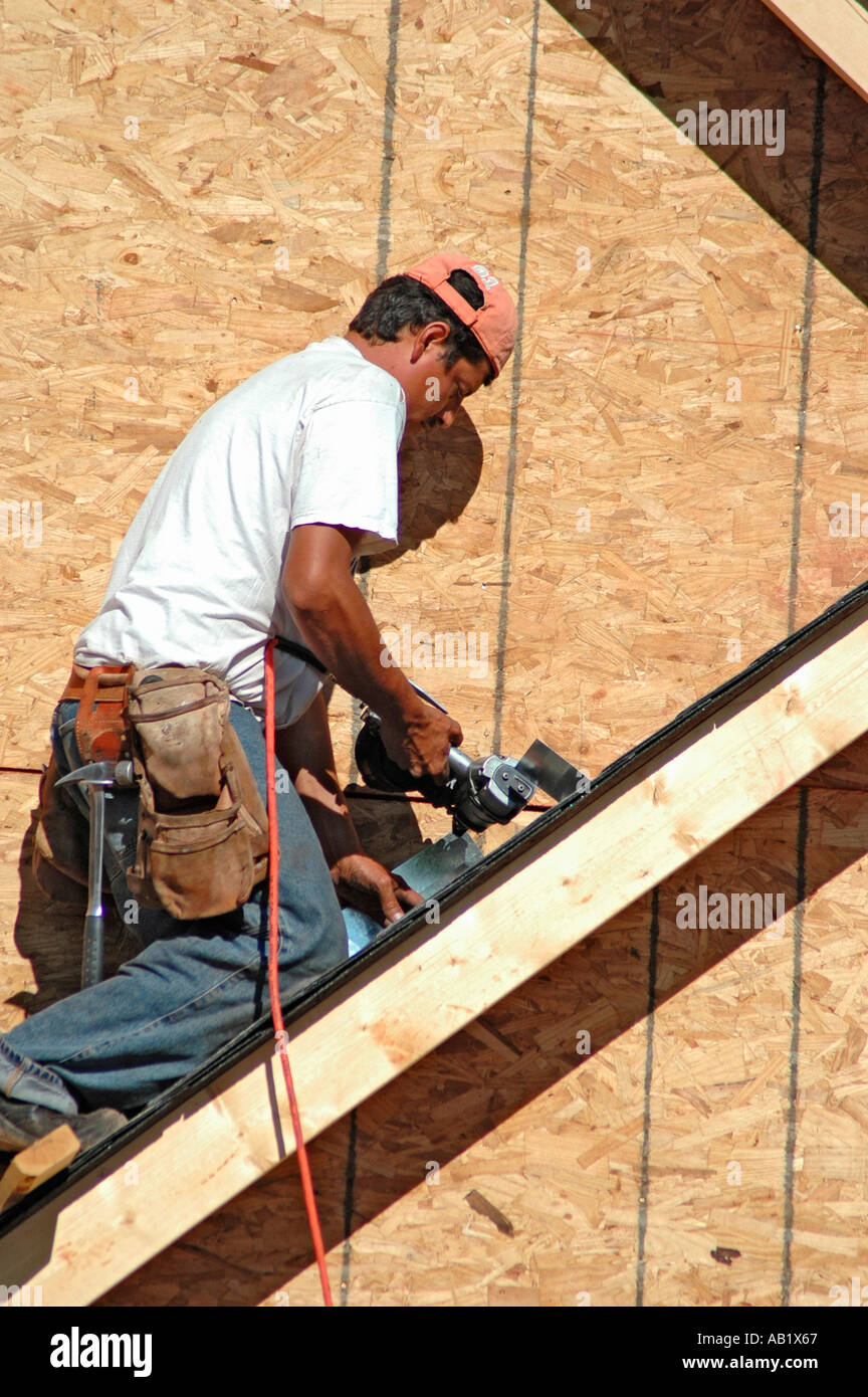 Nailing metal flashing on roof before outer shingles are put down to
