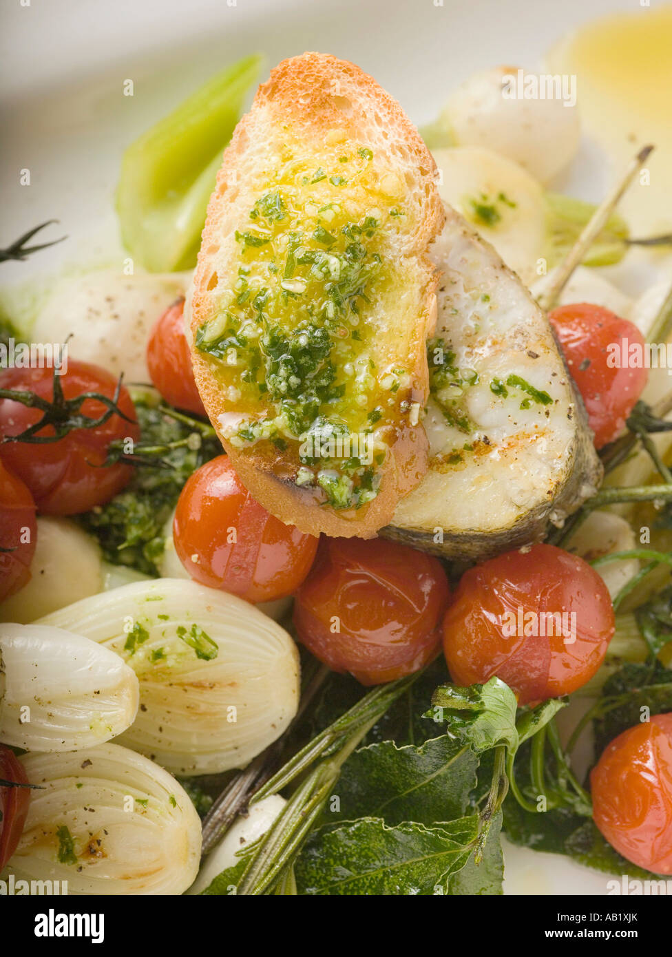 Sea bass cutlet with crostini on roasted vegetables FoodCollection